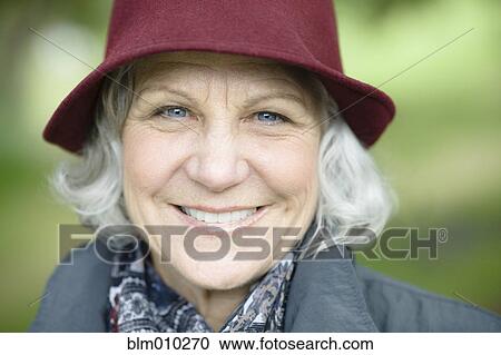Stock Image - Smiling senior Caucasian woman in hat. Fotosearch