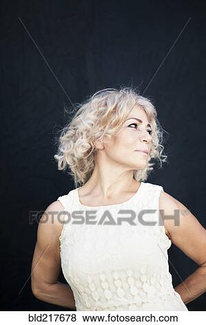 Smiling woman holding hands behind back View Large Photo Image Stock Photo - Smiling woman holding hands behind back. Fotosearch
