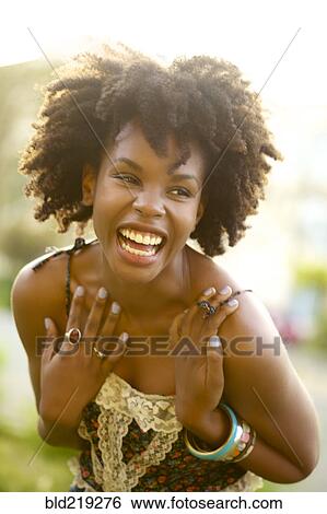 Stock Photograph - Smiling woman laughing outdoors. Fotosearch