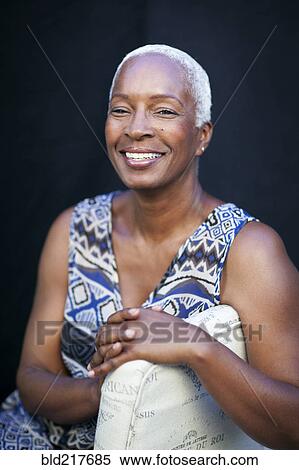 Smiling woman leaning on chair back View Large Photo Image Stock Photography - Smiling woman leaning on chair back. Fotosearch