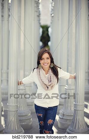 Smiling woman playing in columns View Large Photo Image Stock Photo - Smiling woman playing in columns. Fotosearch