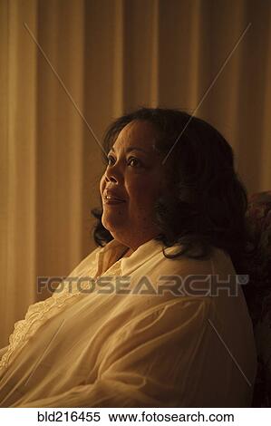 Smiling woman sitting in armchair View Large Photo Image Stock Photography - Smiling woman sitting in armchair. Fotosearch