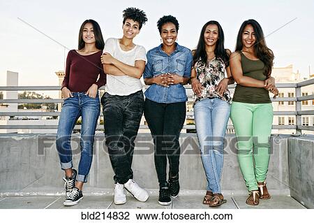 Smiling women standing on urban rooftop View Large Photo Image Stock Image - Smiling women standing on urban rooftop. Fotosearch