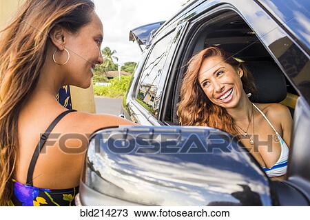 Smiling women talking in car View Large Photo Image Stock Image - Smiling women talking in car. Fotosearch