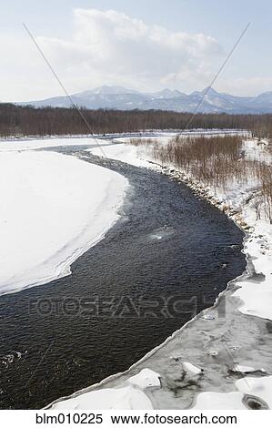 Stock Photography - Snow covered field and stream. Fotosearch