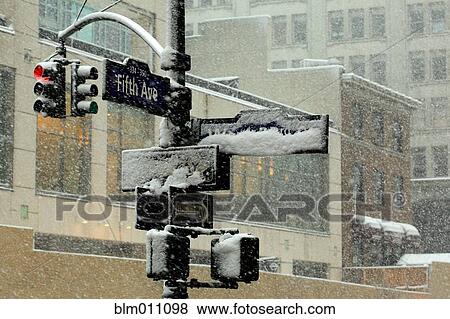 Snow falling on urban streetlight and signs View Large Photo Image Stock Photo - Snow falling on urban streetlight and signs. Fotosearch