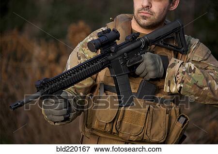 Stock Photo - Soldier aiming automatic weapon during training. Fotosearch