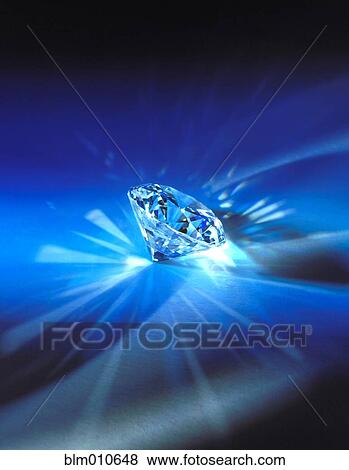 Stock Photo - Sparkling diamond on blue background. Fotosearch