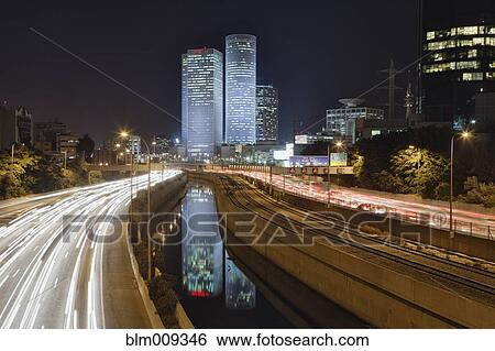 Stock Photograph - Streaking headlights and taillights of city commuter traffic. Fotosearch