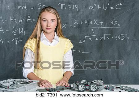 Stock Image - Student building vehicle in science class. Fotosearch