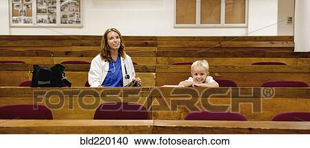 Student doctor and son sitting in college classroom View Large Photo Image Stock Image - Student doctor and son sitting in college classroom. Fotosearch
