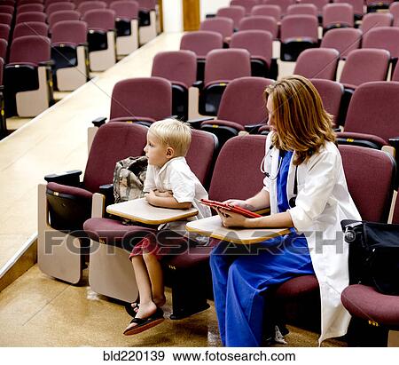 Stock Photo - Student doctor and son sitting in college classroom. Fotosearch