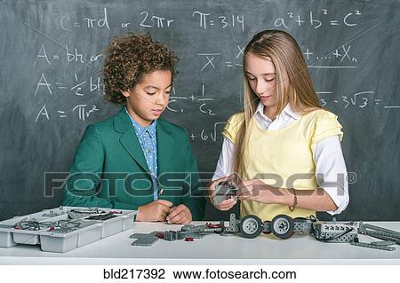 Stock Image - Students building vehicle in science class. Fotosearch