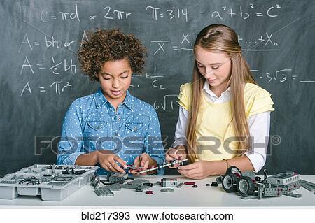 Stock Image - Students building vehicle in science class. Fotosearch