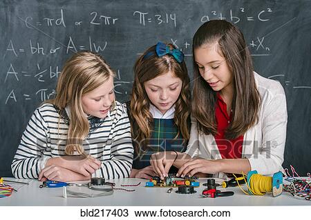 Stock Image - Students building vehicle in science class. Fotosearch