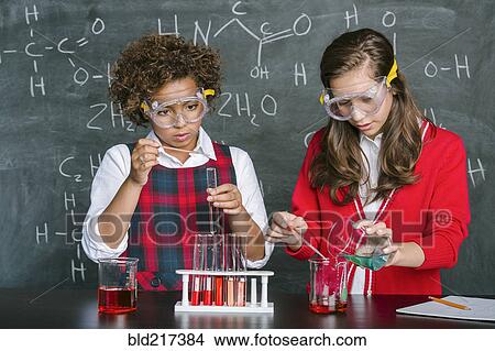 Picture - Students doing experiment in science class. Fotosearch