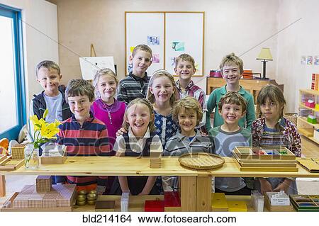 Picture - Students smiling together in classroom. Fotosearch