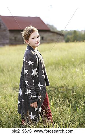 Stylish Caucasian girl walking in rural field View Large Photo Image Stock Image - Stylish Caucasian girl walking in rural field. Fotosearch