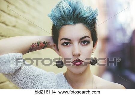 Stylish Caucasian woman with earrings and dyed hair View Large Photo Image Picture - Stylish Caucasian woman with earrings and dyed hair. Fotosearch