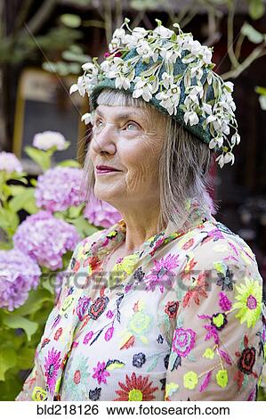 Stock Photograph - Stylish older Caucasian woman wearing floral cap. Fotosearch