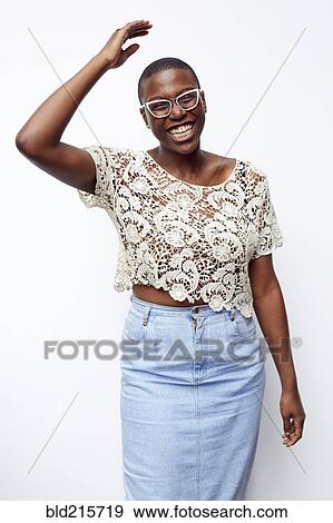 Stock Photo - Stylish smiling woman wearing lace shirt. Fotosearch