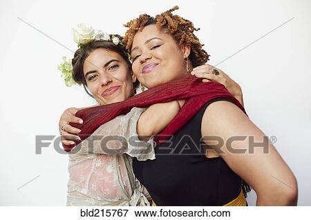 Stock Photo - Stylish smiling women hugging. Fotosearch