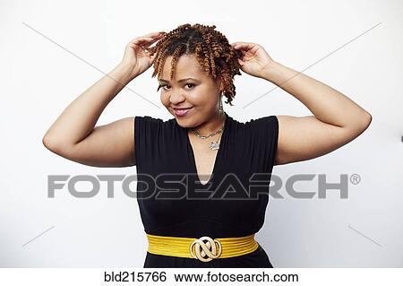 Stock Photograph - Stylish woman posing in dress. Fotosearch