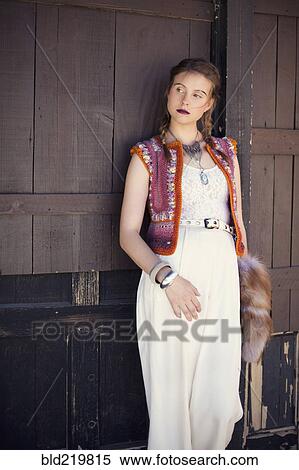 Stock Photography - Stylish woman wearing vest and dress. Fotosearch