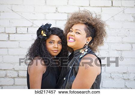 Stylish women smiling outdoors View Large Photo Image Stock Photo - Stylish women smiling outdoors. Fotosearch