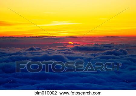 Sun setting over clouds View Large Photo Image Stock Image - Sun setting over clouds. Fotosearch