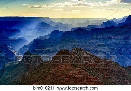 Stock Image - Sunbeams over the Grand Canyon. Fotosearch