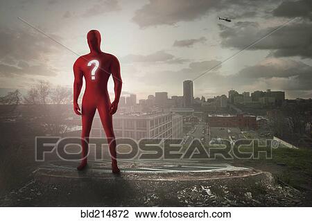 Stock Image - Superhero with question mark costume overlooking cityscape. Fotosearch