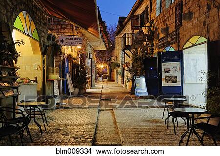 Tables and chairs at cafe at night View Large Photo Image Picture - Tables and chairs at cafe at night. Fotosearch