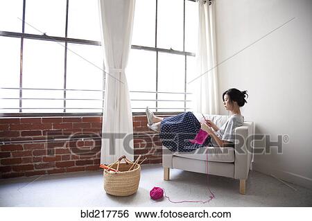 Taiwanese woman knitting in armchair near window View Large Photo Image Stock Photograph - Taiwanese woman knitting in armchair near window. Fotosearch