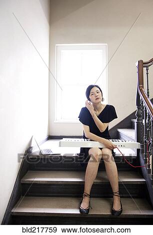 Taiwanese woman playing keyboard on staircase View Large Photo Image Stock Photo - Taiwanese woman playing keyboard on staircase. Fotosearch
