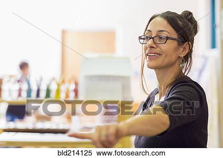 Stock Photography - Teacher gesturing in classroom. Fotosearch