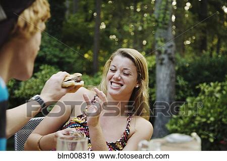 Teenage boy teasing girlfriend with hamburger View Large Photo Image Stock Photo - Teenage boy teasing girlfriend with hamburger. Fotosearch