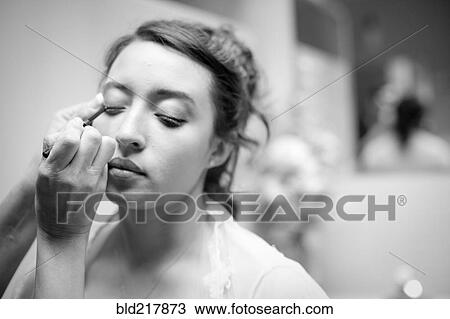 Stock Image - Teenage girl having makeup applied. Fotosearch