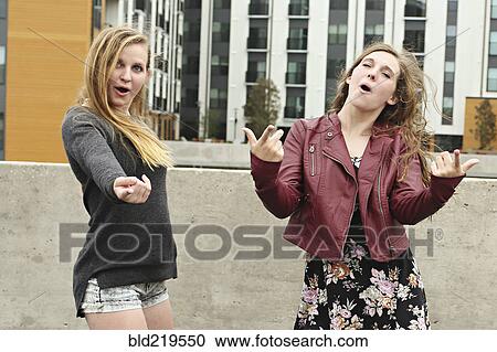 Teenage girls posing on urban rooftop View Large Photo Image Stock Image - Teenage girls posing on urban rooftop. Fotosearch