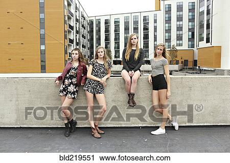 Teenage girls posing on urban rooftop View Large Photo Image Stock Image - Teenage girls posing on urban rooftop. Fotosearch