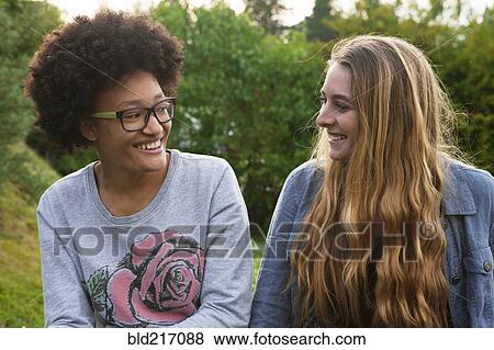 Teenage girls smiling in backyard View Large Photo Image Stock Photo - Teenage girls smiling in backyard. Fotosearch