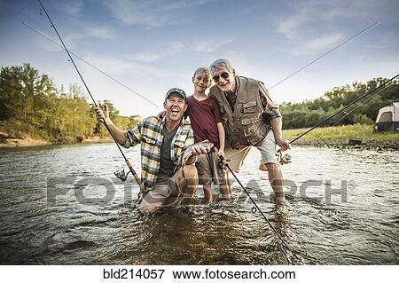 Three generations of Caucasian men fishing in river View Large Photo Image Stock Photo - Three generations of Caucasian men fishing in river. Fotosearch