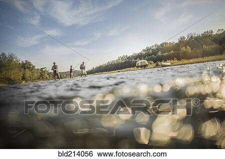 Three generations of Caucasian men fishing in river View Large Photo Image Stock Photograph - Three generations of Caucasian men fishing in river. Fotosearch