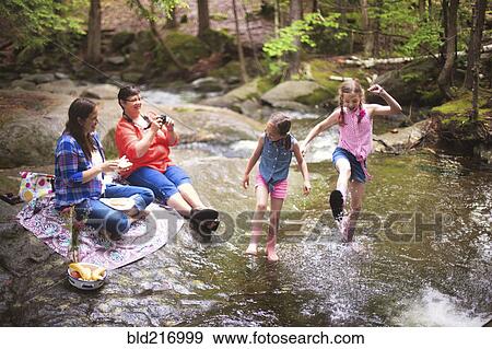 Three generations of Caucasian women playing in river View Large Photo Image Stock Photo - Three generations of Caucasian women playing in river. Fotosearch