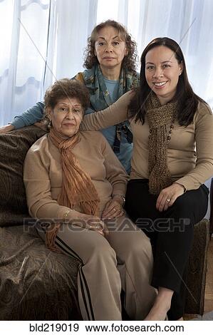 Stock Photo - Three generations of women smiling on sofa. Fotosearch