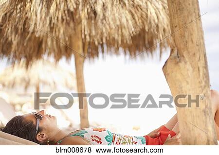 Tranquil Hispanic woman relaxing on vacation View Large Photo Image Stock Photo - Tranquil Hispanic woman relaxing on vacation. Fotosearch
