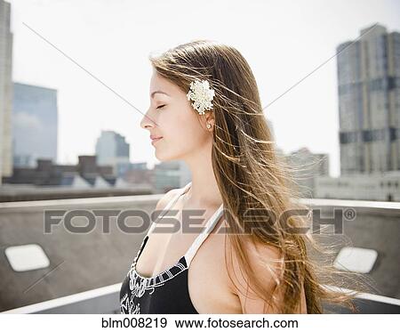 Tranquil Indian woman on urban rooftop View Large Photo Image Stock Photo - Tranquil Indian woman on urban rooftop. Fotosearch