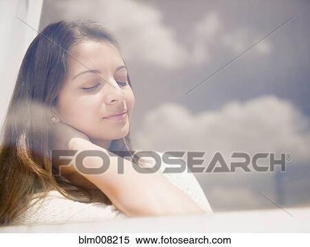 Tranquil Indian woman relaxing View Large Photo Image Stock Photography - Tranquil Indian woman relaxing. Fotosearch