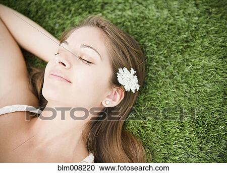 Tranquil Indian woman sleeping in grass View Large Photo Image Stock Image - Tranquil Indian woman sleeping in grass. Fotosearch
