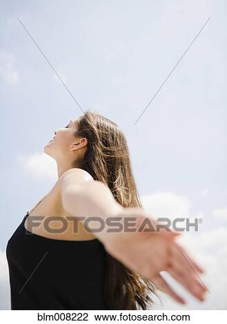 Tranquil Indian woman with arms outstretched View Large Photo Image Stock Image - Tranquil Indian woman with arms outstretched. Fotosearch